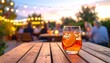 © Nare - Evening scene with a cocktail on a wooden table, blurred background of a gathering