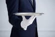 © Meow Creations - Waiter wearing white gloves holding an empty silver serving tray