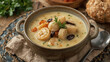 © siraphol - Creamy seafood chowder with scallop and herb garnish, comforting bowl of coastal soup