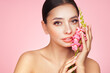 © Oleg Gekman - Portrait beautiful young woman with clean fresh skin. Model with healthy skin, close up portrait. Cosmetology, beauty and spa. Girl with a pink  flower