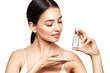 © Oleg Gekman - Beautiful elegant woman holding a cosmetic jar of oil serum or hyaluronic acid in her hand. Perfect facial skin