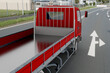 © massimo_g - Camion pianale rosso che percorre una strada con segnaletica orizzontale e area industriale sullo sfondo. Ideale per temi di trasporto, logistica, edilizia, mobilità commerciale e traffico stradale.