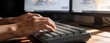 © oeisdesign - Person typing on computer keyboard.