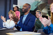© Rido - Group of happy multiethnic business people clapping hands during conference