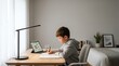 © adi - Focused Child Studying at Desk for Homework