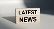 © Blood Group - Latest news text on wooden blocks, breaking news announcement concept, minimalist media and journalism headline on natural wood cubes