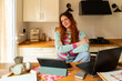 © Alba Vitta Studio/Stocksy - Woman Works at Home in a Bright Kitchen