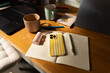 © Alba Vitta Studio/Stocksy - Workspace With Phone, Coffee Mugs, and Notebook on a Wooden Table