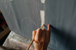 © Olga Moreira/Stocksy - Close-up of artist painting vertical white stroke on canvas