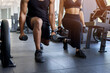 © Anastasiya - Close up of young fitness performing weighted lunges in gym. Lower body strength training, balance, endurance, and workout technique concept