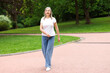 © New Africa - Beautiful senior woman walking in spring park