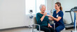 © Xenia - Nurse assisting an elderly woman with an incentive spirometer. Senior patient doing respiratory therapy in a rehabilitation clinic. Healthcare and COPD treatment concept