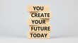 © Clark Still - Wooden letter blocks spell an encouraging future message against a clean gray background.