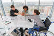 © Юлия Завалишина - Stack of hands. Business startup teamwork unity concept. Top view of diverse multiracial business people putting hands together. Business colleagues during work process rejoice in success of company