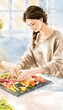 © decorator - Cozy morning kitchen scene a young woman arranges vibrant vegetables on slate platter