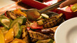 © blueringmedia - Metal Tongs Serving Grilled Zucchini and Eggplant at a Buffet