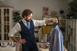 © Miljan Živković - Man choosing outfit getting dressed in sophisticated fashion