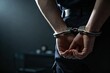© ArikEkaSatya - Close up of Handcuffs with Police Officer