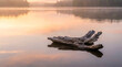 © FadhilKey - Serene Driftwood Floating on a Mirror-Like Lake During a Golden Hour Sunrise in the Wilderness