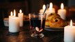 © Brata - Traditional Swedish mulled wine glögg with raisins and almonds served with saffron buns on a rustic table lit by warm candles.