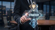 © SM Graphics - Businessman touching screen with strategy diamond shaped icon lightbulb and chess horse.