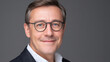 © Keopaserth - Portrait man adult middle aged glasses face smile studio gray background headshot business professional formal caucasian male closeup clean confident friendly office isolated short hair blue eyes