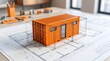 © Yusuf - Orange Shipping Container House Architectural Model on Structural Blueprint Planning Table
