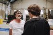 © Luciano Spinelli/Stocksy - Two Men Engaged in Conversation