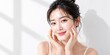 © MstRehena - Young asian woman with glowing clear skin touching her face in soft natural morning sunlight portrait