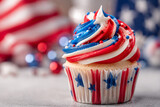 Close up shot of patriotic cupcake decorated with red white and blue frosting and stars for holiday.