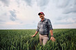 © Drazen - Successful agricultural producer in wheat field looking at camera.