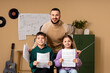© Pixel-Shot - Music teacher with young students holding sheet music in classroom, music education and learning