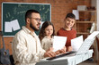 © Pixel-Shot - Music teacher guiding young students in piano lesson, learning musical notes and instrument skills in classroom, the classroom setting fosters education and creativity as the children practice