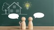 © YiuCheung - Two wooden figures discuss a home with keys and a lightbulb idea on chalkboard.