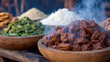 © Oksana - A rustic, steaming spread of traditional African-inspired dishes, featuring tender stewed meat, vibrant green vegetables, and white grains served in wooden bowls on a weathered table.