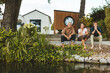 © Westend61 - Senior man sitting my woman and son on steps at backyard