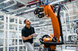 © Westend61 - Technician examining industrial robot in a factory