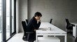 © arga - A thoughtful man in a business setting, contemplating a decision while sitting at a desk in a modern office environment, contemplating his next move