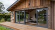 © Sergej - Modern building with wooden facade, stone pillar, and sliding glass doors