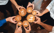 © InfiniteFlow - A dynamic scene showcasing diverse hands holding wooden gears with symbols of sustainability and innovation, highlighting collaboration in green business practices. Amity