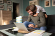 © Niyaz Tavkaev/Stocksy - Man working remotely and playing with son at home