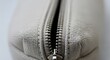 © PixelWeave - Close up view of a metal zipper on a fabric bag or garment in soft lighting. customizable canvas pouch