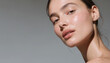 © Asiya - Woman's radiant face with natural glow during soft studio lighting and selective focus for skincare advertising