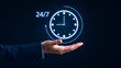 © Technolog - Businessman holding a glowing 247 clock icon in his hand, representing continuous availability, roundtheclock service, and constant support in business