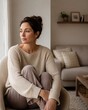 © Johannes - Woman sitting in a cozy chair reflecting in a modern living room
