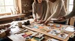 © Batlimos - Hands Assembling Vision Board with Photos and Paper