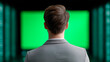 © MargoArt - Back view of businessman in grey suit looking at large glowing green screen