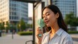 © Photo Moon - Summer Heat - Young Asian Woman Using Mint Green Handheld Mini Fan Outdoors in Urban City Setting