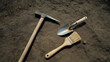© Ali - Three essential archaeological tools laid out on a dirt surface for excavation work