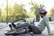 © Pixel-Shot - Sporty young man fallen off his bike in park